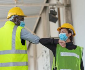 Warehouse workers in facemasks