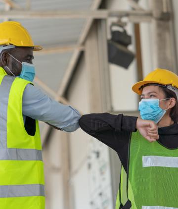Warehouse workers in facemasks