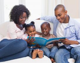 Black family reading storybook